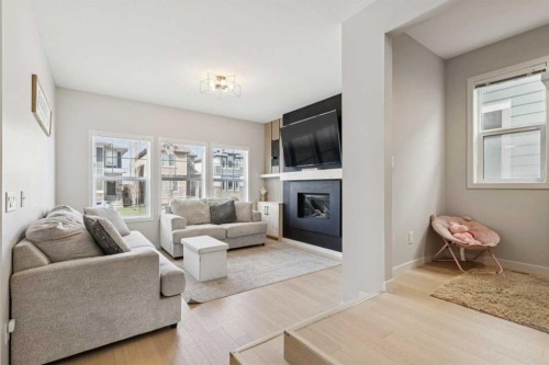 325 Marquis Heights Se, Calgary, AB - Indoor Photo Showing Living Room With Fireplace