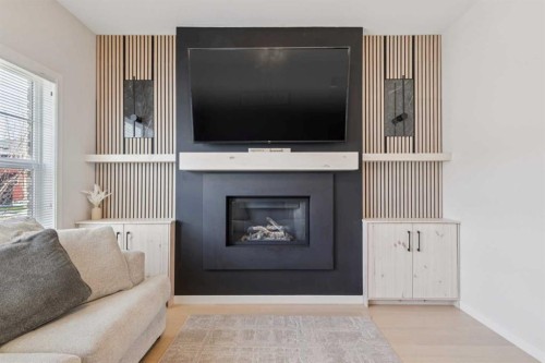 325 Marquis Heights Se, Calgary, AB - Indoor Photo Showing Living Room With Fireplace
