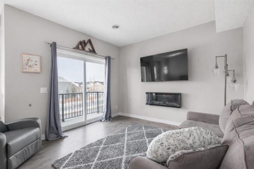 811-250 Fireside View, Cochrane, AB - Indoor Photo Showing Living Room With Fireplace