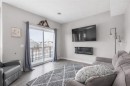 811-250 Fireside View, Cochrane, AB  - Indoor Photo Showing Living Room With Fireplace 