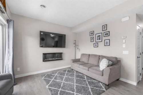 811-250 Fireside View, Cochrane, AB - Indoor Photo Showing Living Room With Fireplace