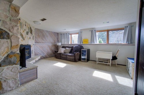 47 Willow Road, Claresholm, AB - Indoor Photo Showing Living Room With Fireplace