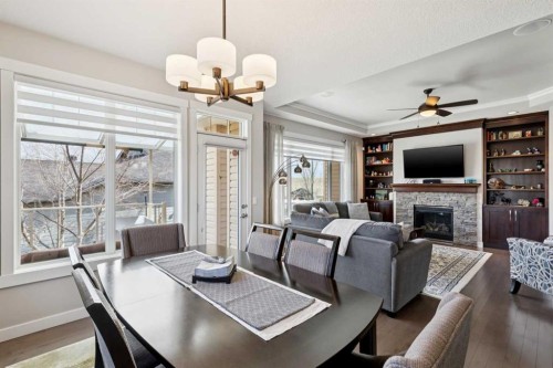 101 Sheep River Crest, Okotoks, AB - Indoor Photo Showing Dining Room With Fireplace