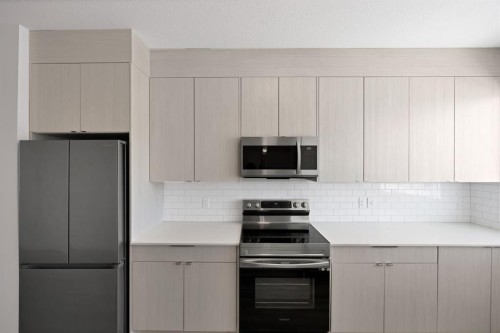 105-101 Panatella Square Nw, Calgary, AB - Indoor Photo Showing Kitchen