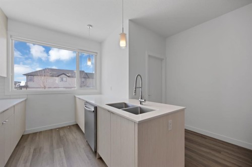 105-101 Panatella Square Nw, Calgary, AB - Indoor Photo Showing Kitchen With Double Sink