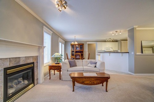 26 Skyline Crescent, Claresholm, AB - Indoor Photo Showing Living Room With Fireplace