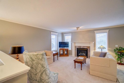 26 Skyline Crescent, Claresholm, AB - Indoor Photo Showing Living Room With Fireplace