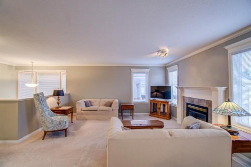 26 Skyline Crescent, Claresholm, AB - Indoor Photo Showing Living Room With Fireplace