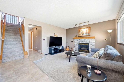 129 Arbour Ridge Circle Nw, Calgary, AB - Indoor Photo Showing Living Room With Fireplace