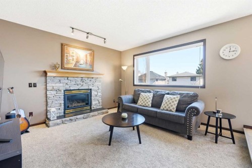 129 Arbour Ridge Circle Nw, Calgary, AB - Indoor Photo Showing Living Room With Fireplace