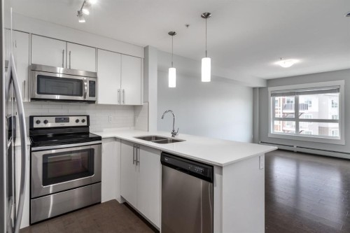 7309-302 Skyview Ranch Drive Ne, Calgary, AB - Indoor Photo Showing Kitchen With Stainless Steel Kitchen With Double Sink With Upgraded Kitchen