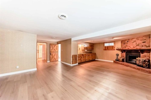 7427 25 Street Se, Calgary, AB - Indoor Photo Showing Living Room With Fireplace