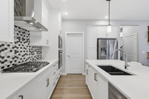 902 Bluerock Way Sw, Calgary, AB - Indoor Photo Showing Kitchen With Double Sink With Upgraded Kitchen