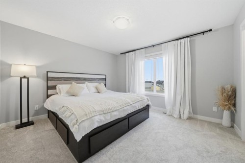 902 Bluerock Way Sw, Calgary, AB - Indoor Photo Showing Bedroom
