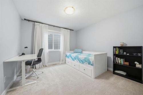 902 Bluerock Way Sw, Calgary, AB - Indoor Photo Showing Bedroom