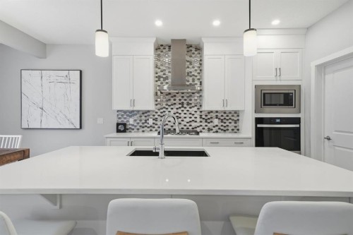 902 Bluerock Way Sw, Calgary, AB - Indoor Photo Showing Kitchen With Upgraded Kitchen