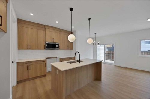 82 Heritage Circle, Cochrane, AB - Indoor Photo Showing Kitchen With Double Sink With Upgraded Kitchen