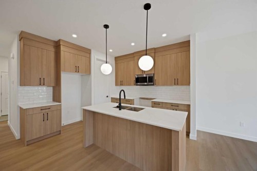 82 Heritage Circle, Cochrane, AB - Indoor Photo Showing Kitchen With Double Sink