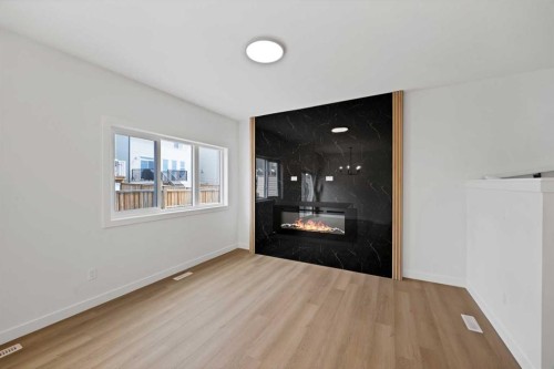 82 Heritage Circle, Cochrane, AB - Indoor Photo Showing Other Room With Fireplace
