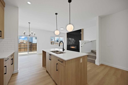 82 Heritage Circle, Cochrane, AB - Indoor Photo Showing Kitchen With Double Sink With Upgraded Kitchen