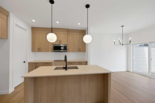 82 Heritage Circle, Cochrane, AB - Indoor Photo Showing Kitchen With Double Sink With Upgraded Kitchen