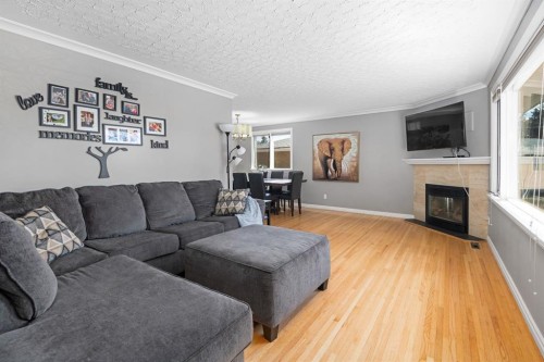 3144 Breen Crescent Nw, Calgary, AB - Indoor Photo Showing Living Room With Fireplace