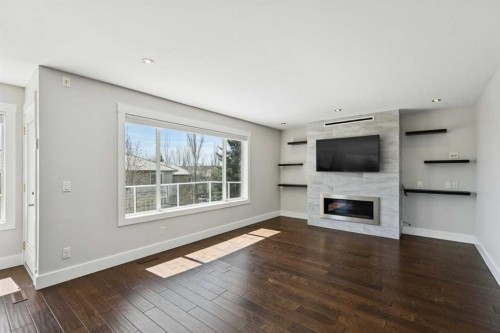 15 Springbank View Sw, Calgary, AB - Indoor Photo Showing Living Room With Fireplace
