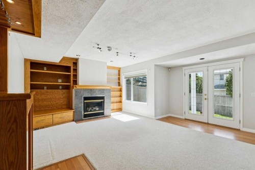15 Springbank View Sw, Calgary, AB - Indoor Photo Showing Other Room With Fireplace