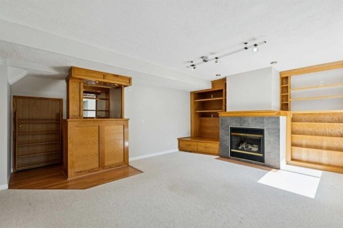 15 Springbank View Sw, Calgary, AB - Indoor Photo Showing Living Room With Fireplace