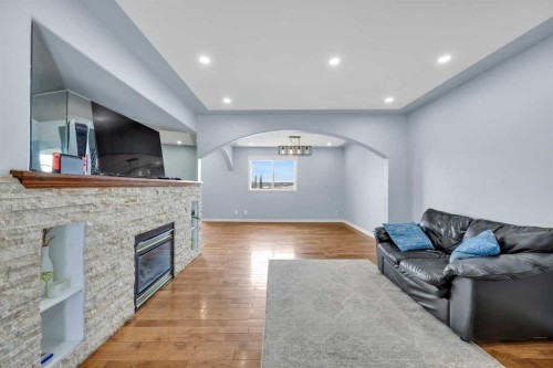166 Tuscarora Close Nw, Calgary, AB - Indoor Photo Showing Living Room With Fireplace