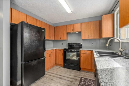 19 Bernard Drive Nw, Calgary, AB - Indoor Photo Showing Kitchen With Double Sink
