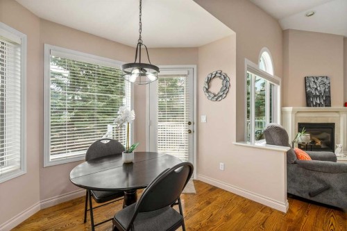28 Hamptons Rise Nw, Calgary, AB - Indoor Photo Showing Dining Room With Fireplace