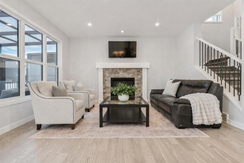 55 Sundown Crescent, Cochrane, AB - Indoor Photo Showing Living Room With Fireplace