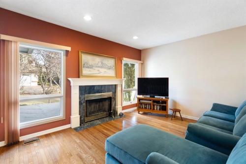 118 Shawnee Place Sw, Calgary, AB - Indoor Photo Showing Living Room With Fireplace