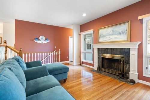 118 Shawnee Place Sw, Calgary, AB - Indoor Photo Showing Living Room With Fireplace