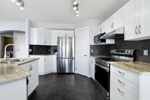 57 Bridlecrest Court Sw, Calgary, AB - Indoor Photo Showing Kitchen With Double Sink With Upgraded Kitchen