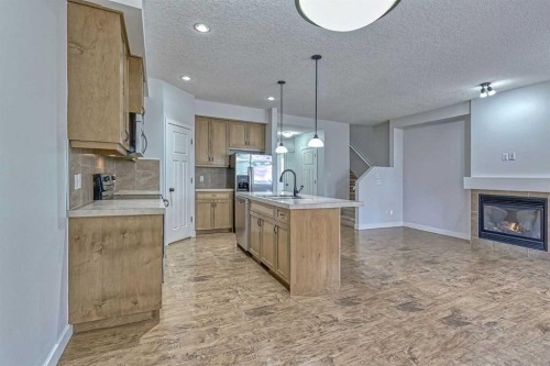 508-413 River Avenue, Cochrane, AB - Indoor Photo Showing Kitchen With Fireplace