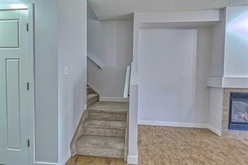 508-413 River Avenue, Cochrane, AB - Indoor Photo Showing Other Room With Fireplace