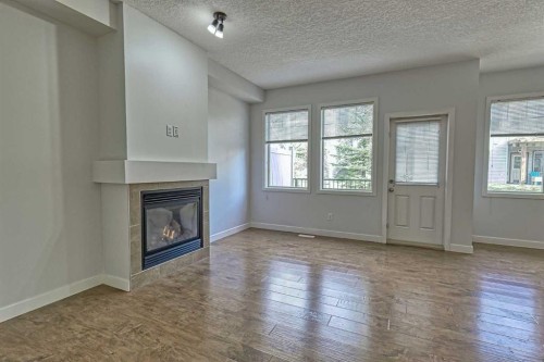 508-413 River Avenue, Cochrane, AB - Indoor Photo Showing Other Room With Fireplace