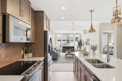 207-39 Quarry Gate Se, Calgary, AB - Indoor Photo Showing Kitchen With Stainless Steel Kitchen With Double Sink With Upgraded Kitchen