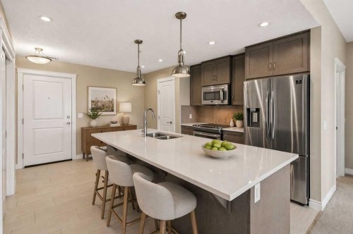 207-39 Quarry Gate Se, Calgary, AB - Indoor Photo Showing Kitchen With Stainless Steel Kitchen With Double Sink With Upgraded Kitchen