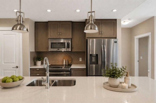 207-39 Quarry Gate Se, Calgary, AB - Indoor Photo Showing Kitchen With Stainless Steel Kitchen With Double Sink With Upgraded Kitchen