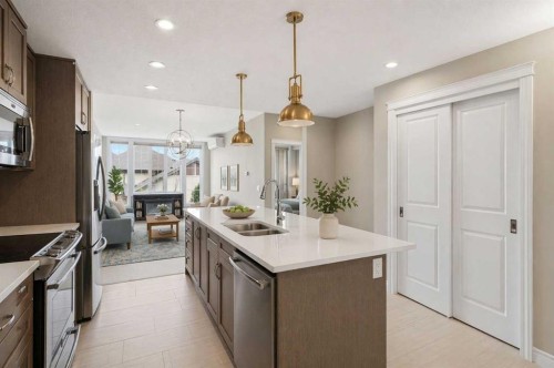 207-39 Quarry Gate Se, Calgary, AB - Indoor Photo Showing Kitchen With Stainless Steel Kitchen With Double Sink With Upgraded Kitchen