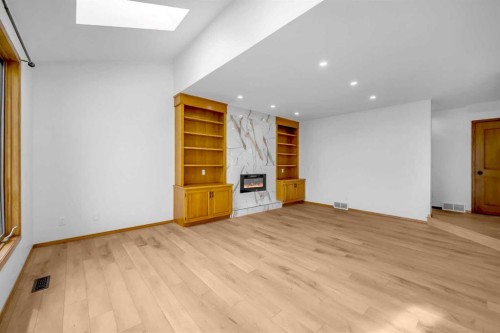208 Coral Shores Bay Ne, Calgary, AB - Indoor Photo Showing Other Room With Fireplace