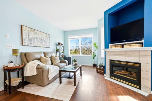 207-60 Promenade Way Se, Calgary, AB - Indoor Photo Showing Living Room With Fireplace