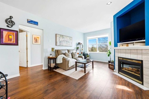 207-60 Promenade Way Se, Calgary, AB - Indoor Photo Showing Living Room With Fireplace
