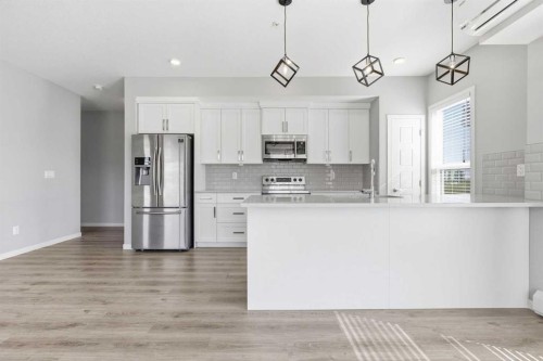 204-4150 Seton Drive Se, Calgary, AB - Indoor Photo Showing Kitchen With Stainless Steel Kitchen With Upgraded Kitchen