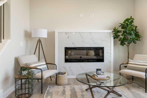 450 Kinniburgh Loop, Chestermere, AB - Indoor Photo Showing Living Room With Fireplace