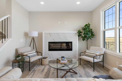 450 Kinniburgh Loop, Chestermere, AB - Indoor Photo Showing Living Room With Fireplace