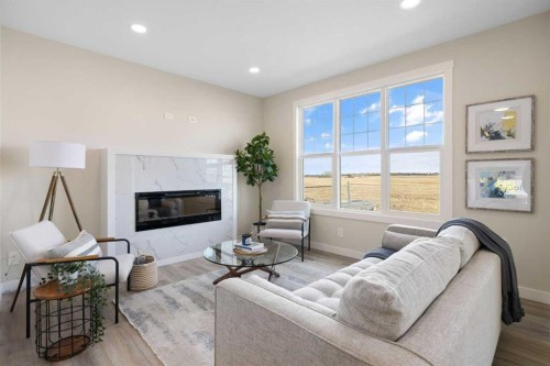 450 Kinniburgh Loop, Chestermere, AB - Indoor Photo Showing Living Room With Fireplace